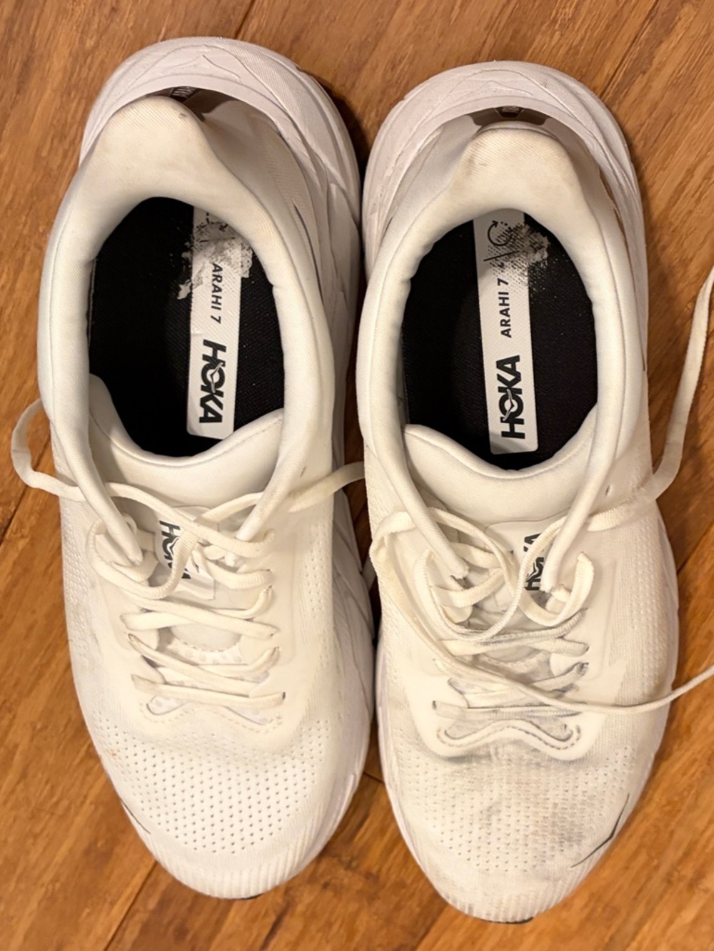 Hoka One One label with blue logo on black and white tag